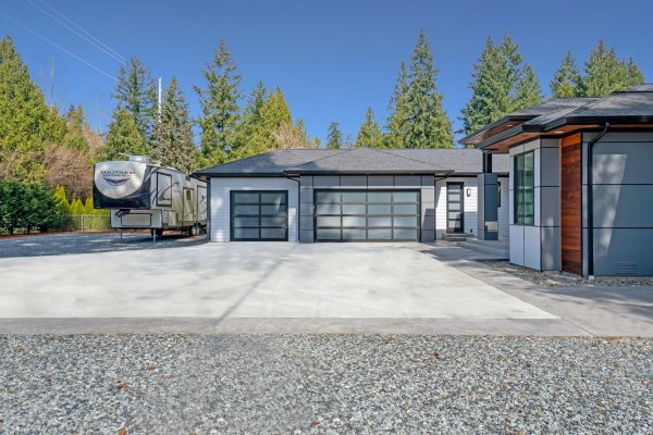 newly built home with an RV parked in the driveway